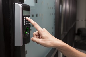 person using biometric access control keypad